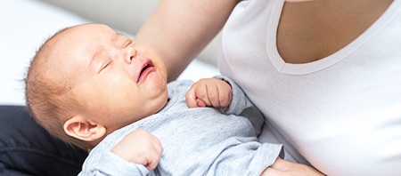 Mother holding her fussy baby