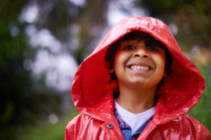 little boy smiling in raincoat