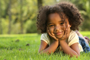 little girl posing in the grass