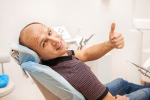 man smiling in the dental chair