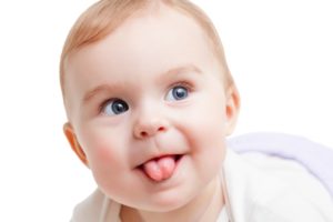 Baby sticking out tongue after frenectomy in Southlake.