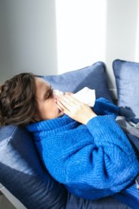 Woman with a cold at holistic dentist in Southlake.