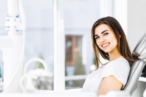 Happy female patient visiting holistic dentist in Southlake