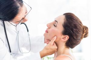 Holistic dentist in Southlake carefully examining patient’s jaw