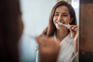 Brushing teeth, following directions of holistic dentist in Southlake