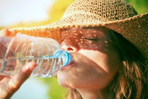 Woman drinking water for hydration and oral health in Southlake