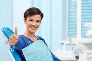 Happy patient giving thumbs up for laser dentistry in Southlake