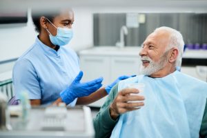 Dentist and patient having friendly conversation
