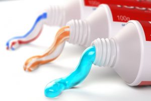 Three tubes of toothpaste against white background