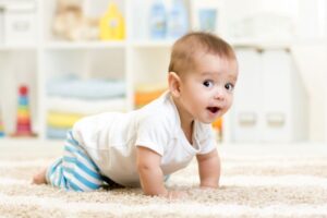 Happy baby crawling on floor