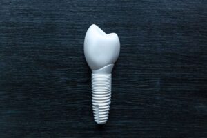 Zirconia implant and crown against dark background