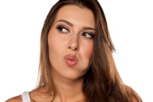 Thoughtful woman moving her tongue around her mouth